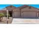 Charming single-story home featuring a two-car garage, desert landscaping, and a well-maintained front yard at 12941 W Flower St, Avondale, AZ 85392