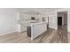 A modern kitchen with stainless steel appliances, granite counters, and a breakfast bar at 12941 W Flower St, Avondale, AZ 85392