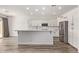 A bright kitchen with white cabinets, stainless steel appliances, and a large center island at 12941 W Flower St, Avondale, AZ 85392