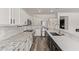 A modern kitchen featuring white cabinets, granite countertops, and stainless-steel appliances at 12941 W Flower St, Avondale, AZ 85392