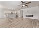 Open concept kitchen with stainless steel appliances, large island, and fireplace at 12941 W Flower St, Avondale, AZ 85392