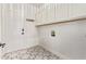 This laundry room features stylish floors, lots of storage, and modern lighting at 12941 W Flower St, Avondale, AZ 85392