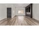 Spacious living room with wood floors, black built-in shelving, a front door and bright natural light at 12941 W Flower St, Avondale, AZ 85392