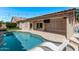 Relaxing backyard pool with a covered patio, creating an ideal spot for lounging and outdoor entertainment at 12941 W Flower St, Avondale, AZ 85392