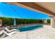 This backyard features a refreshing pool and lounge seating at 12941 W Flower St, Avondale, AZ 85392