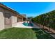 Inviting backyard pool features lush green landscaping and offers a private outdoor oasis at 12941 W Flower St, Avondale, AZ 85392