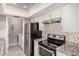 Modern kitchen featuring stainless steel refrigerator and oven with stone backsplash at 1342 W Emerald Ave # 381, Mesa, AZ 85202