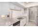 Stylish kitchen featuring granite countertops, stainless steel appliances, and white cabinetry at 1342 W Emerald Ave # 381, Mesa, AZ 85202