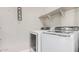This laundry room features Samsung washer and dryer and open shelving at 1342 W Emerald Ave # 381, Mesa, AZ 85202