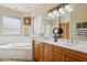 Relaxing main bathroom with soaking tub, dual vanities, glass block window, and walk-in shower at 13600 N Fountain Hills Blvd # 405, Fountain Hills, AZ 85268
