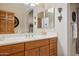 Bathroom with wooden cabinets, white countertops, and decorative accents creating a warm ambiance at 13600 N Fountain Hills Blvd # 405, Fountain Hills, AZ 85268