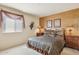 Comfortable bedroom featuring neutral walls, side tables, lamps and a decorated bronze accent wall at 13600 N Fountain Hills Blvd # 405, Fountain Hills, AZ 85268