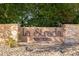 La Strada community sign with stacked stone base and lush green landscaping at 13600 N Fountain Hills Blvd # 405, Fountain Hills, AZ 85268
