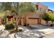 Inviting two-story home showcasing desert landscaping, private gate, and a convenient two-car garage at 13600 N Fountain Hills Blvd # 405, Fountain Hills, AZ 85268