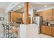 Charming kitchen with granite counters, wood cabinets, stainless refrigerator, and breakfast bar seating at 13600 N Fountain Hills Blvd # 405, Fountain Hills, AZ 85268
