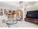 Open living room with breakfast bar, television, and tiled floors at 13600 N Fountain Hills Blvd # 405, Fountain Hills, AZ 85268