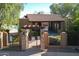 Community pool area featuring a shaded ramada, gated entrance, and well-maintained landscaping at 13600 N Fountain Hills Blvd # 405, Fountain Hills, AZ 85268