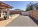 View of backyard with decorative wall, rockscape and the sparkling pool in the background at 14437 W Lexington Ave, Goodyear, AZ 85395