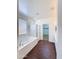 Bright bathroom featuring a soaking tub, separate shower and a walk-in closet at 14437 W Lexington Ave, Goodyear, AZ 85395