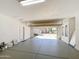 Clean two-car garage with epoxy flooring, featuring an open garage door showcasing the exterior at 14437 W Lexington Ave, Goodyear, AZ 85395