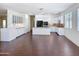 Open-concept kitchen with granite countertops, white cabinetry, and stainless steel appliances at 14437 W Lexington Ave, Goodyear, AZ 85395