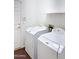 Laundry room featuring white appliances and tile floors next to an exterior door at 14437 W Lexington Ave, Goodyear, AZ 85395