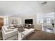 Bright living room featuring contemporary furniture, a large television, and an open layout perfect for entertaining at 14437 W Lexington Ave, Goodyear, AZ 85395