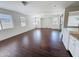 Open living room area with wood-look flooring, lots of windows, and neutral paint at 14437 W Lexington Ave, Goodyear, AZ 85395