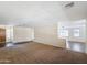 Spacious living room featuring neutral carpet and lots of natural light at 14437 W Lexington Ave, Goodyear, AZ 85395