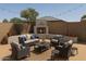 Inviting outdoor patio featuring a cozy fireplace and comfortable seating area, perfect for relaxing and entertaining at 14437 W Lexington Ave, Goodyear, AZ 85395
