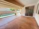 Covered patio area with view of the pool provides ample space for outdoor entertaining at 14437 W Lexington Ave, Goodyear, AZ 85395