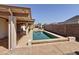 Shot of the backyard pool and the home's covered patio, an ideal space for relaxing at 14437 W Lexington Ave, Goodyear, AZ 85395