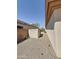 Side yard features a decorative outbuilding and low maintenance rock landscape at 14437 W Lexington Ave, Goodyear, AZ 85395