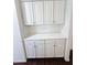 A built-in storage solution featuring white cabinets and drawers with a countertop at 14437 W Lexington Ave, Goodyear, AZ 85395