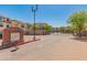Community entrance with brick-paved road and a welcoming sign on a sunny day at 14575 W Mountain View Blvd # 10313, Surprise, AZ 85374