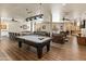 Spacious game room with a pool table, lounge area, and communal tables at 14575 W Mountain View Blvd # 10313, Surprise, AZ 85374