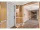 Hallway entrance with a white door featuring warm neutral walls and patterned flooring at 14575 W Mountain View Blvd # 10313, Surprise, AZ 85374