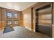 Hallway near an elevator featuring neutral decor and patterned flooring at 14575 W Mountain View Blvd # 10313, Surprise, AZ 85374