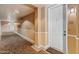 Hallway entrance with a white door featuring warm neutral walls and patterned flooring at 14575 W Mountain View Blvd # 10313, Surprise, AZ 85374