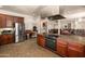 Communal kitchen with granite counters, ample cabinets, stainless appliances, and views of common area at 14575 W Mountain View Blvd # 10313, Surprise, AZ 85374