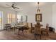 Comfortable living room featuring wood floors, a ceiling fan, and natural light from the large windows with plantation shutters at 14575 W Mountain View Blvd # 10313, Surprise, AZ 85374