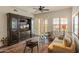 Inviting living room with wood floors, a ceiling fan, comfortable seating, and plantation shutters at 14575 W Mountain View Blvd # 10313, Surprise, AZ 85374