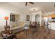 Open concept living room showcasing wood floors, comfortable seating, and easy access to the kitchen at 14575 W Mountain View Blvd # 10313, Surprise, AZ 85374
