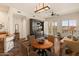 Open-concept living area with a dining table, media center, and balcony view at 14575 W Mountain View Blvd # 10313, Surprise, AZ 85374