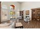 Bright lobby featuring wood floors, a fireplace, and built-in bookshelves at 14575 W Mountain View Blvd # 10313, Surprise, AZ 85374