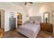 Stylish main bedroom with hardwood floors, en-suite access to bath, and comfortable furniture at 14575 W Mountain View Blvd # 10313, Surprise, AZ 85374