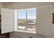 Bright window with open shutters offers panoramic view of neighborhood, mountain range, and blue sky at 14575 W Mountain View Blvd # 10313, Surprise, AZ 85374