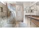 Well-lit bathroom with a large shower with glass enclosure, a vanity, and stone countertops at 14655 N Kings Way, Fountain Hills, AZ 85268