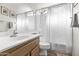 Well-lit bathroom with a vanity, sink, toilet, and tub-shower combo with a white patterned curtain at 14655 N Kings Way, Fountain Hills, AZ 85268