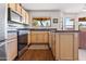 Well-lit kitchen with stainless steel appliances and a breakfast bar with natural light at 14655 N Kings Way, Fountain Hills, AZ 85268